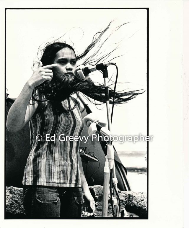 Terri Kekoʻolani speaking at a Save Our Surf protest demo at Sandy Beach. (1970ʻs) Negative: 2506-2-8 | Ed Greevy Photographer