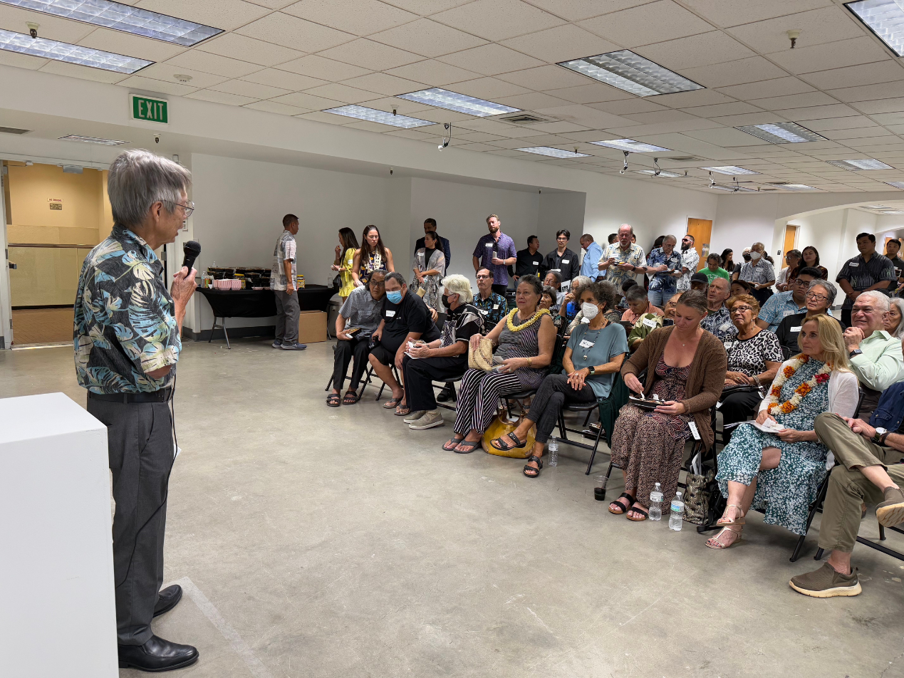 Another view of Wayson Chow addressing the room